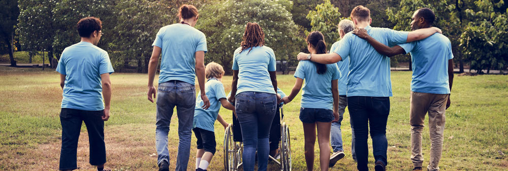 A group of people walking in a park